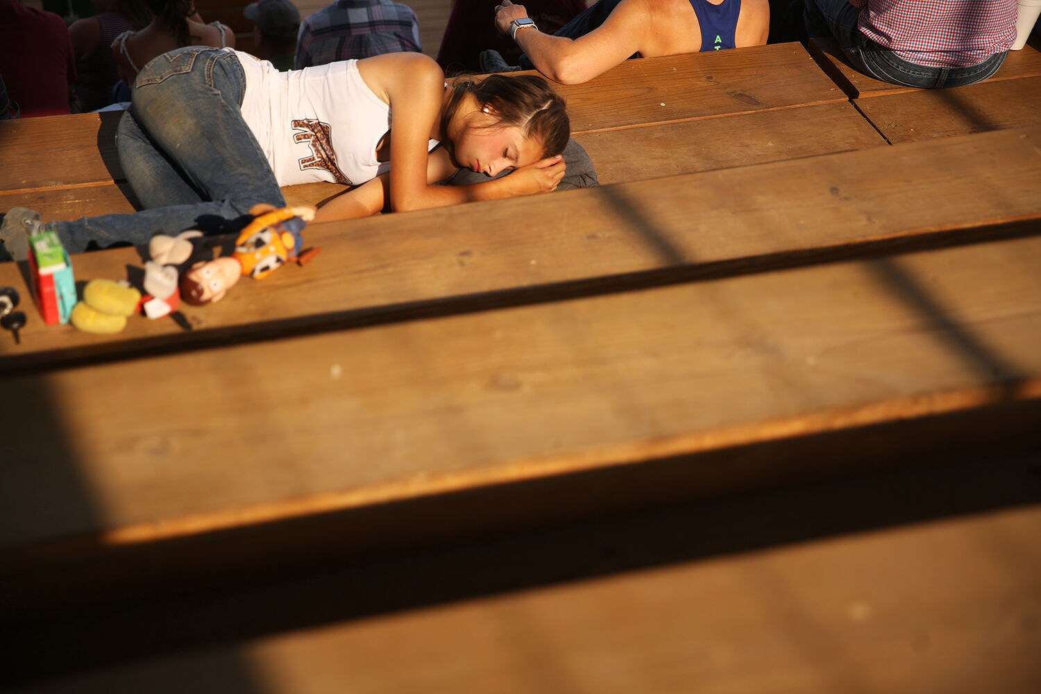 Klarissa Painter naps in the sun in the bleachers